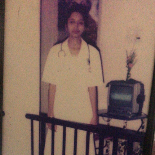 A photograph of Abheena Jacob as a nurse in India.
